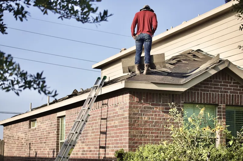 Professional roofer working on a residential roof in Breyer